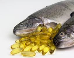 Two dead fishes with yellow fish oil pills