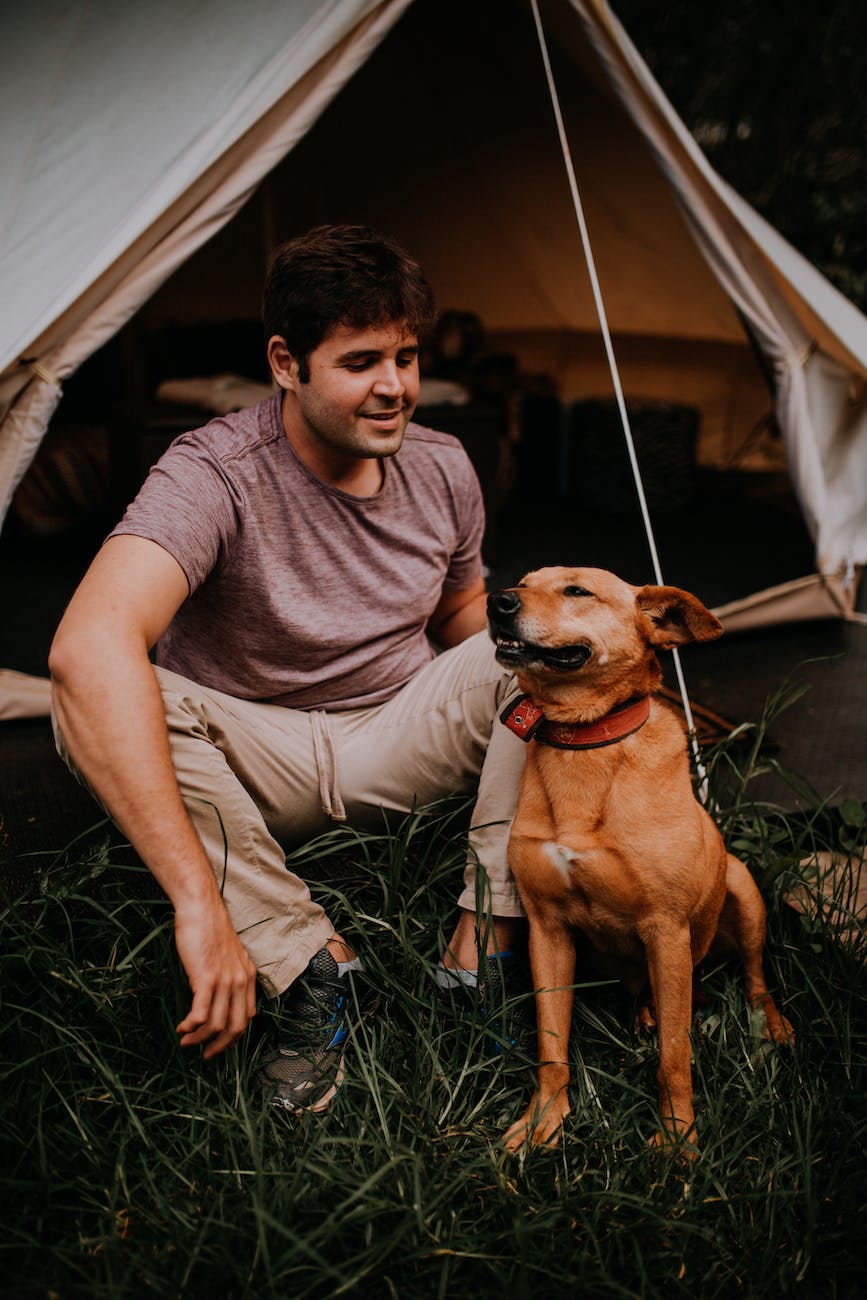 Man in a tent with his dog